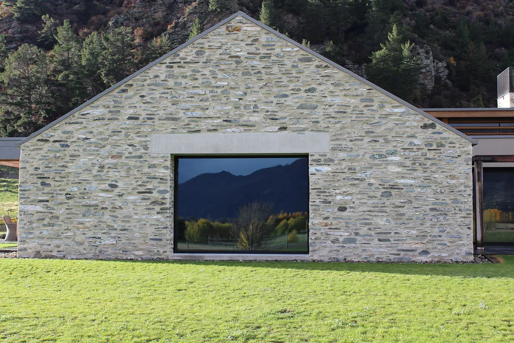 Schist-clad home with a large picture window, Wanaka