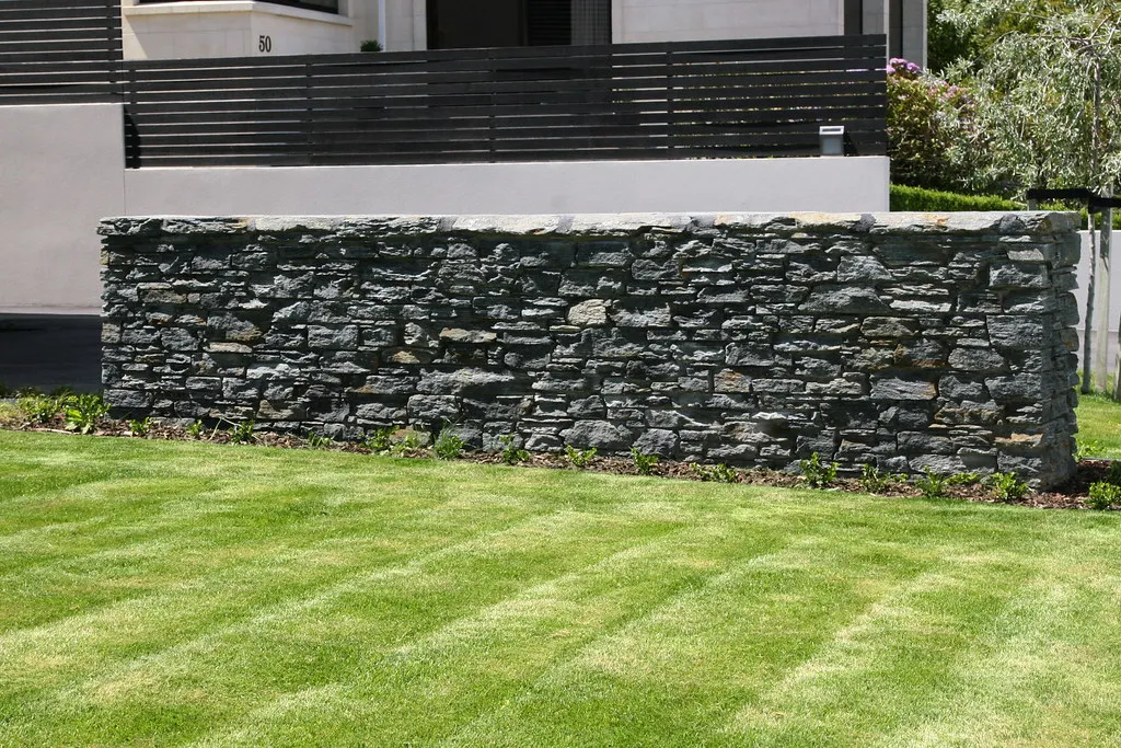 Free-standing schist garden wall on a lawn, Frankton